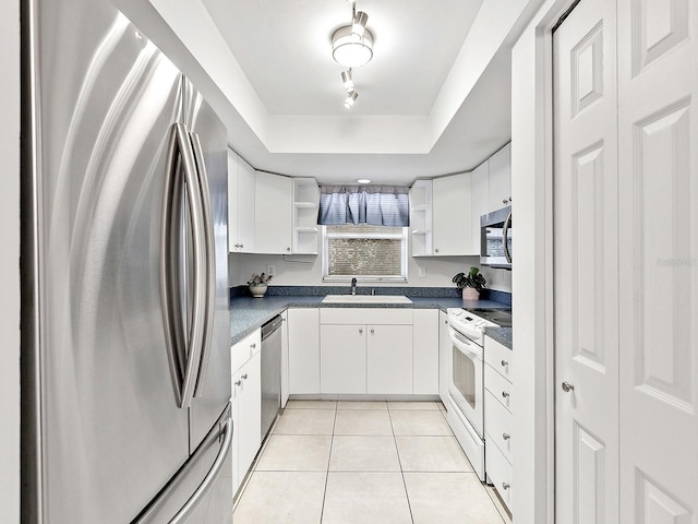 kitchen featuring white cabinetry, light tile patterned floors, and appliances with stainless steel finishes