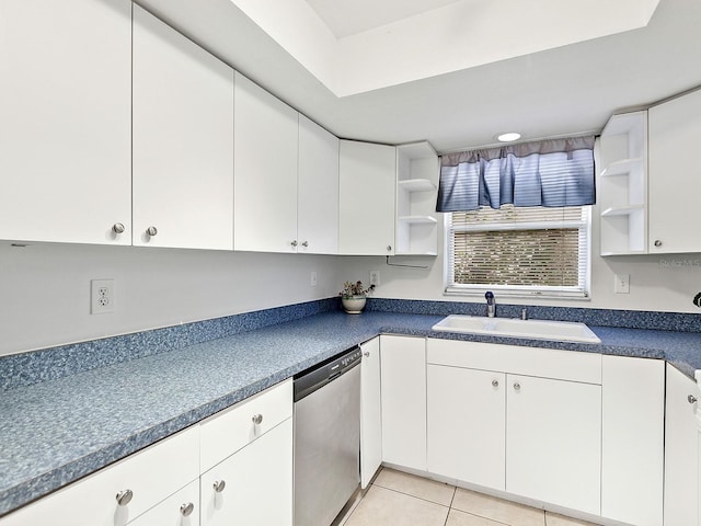 kitchen featuring light tile patterned flooring, sink, white cabinets, and stainless steel dishwasher