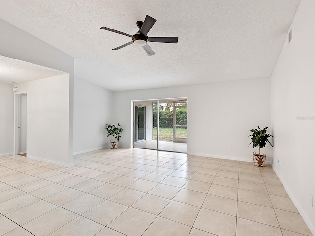 tiled spare room with ceiling fan and a textured ceiling