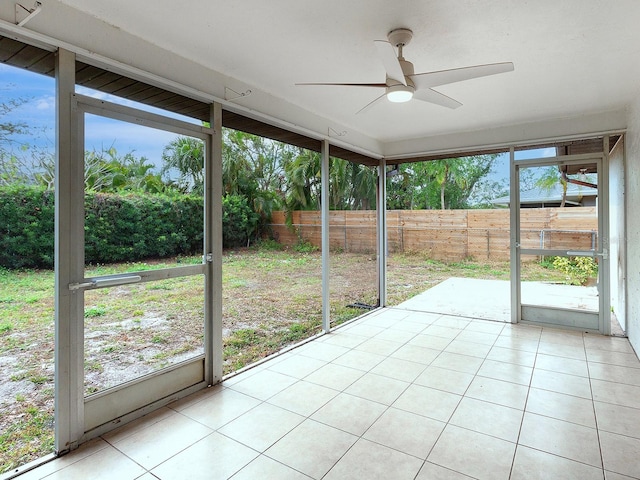 unfurnished sunroom featuring ceiling fan