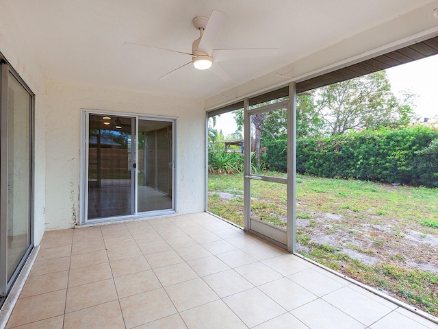 unfurnished sunroom with ceiling fan and a healthy amount of sunlight