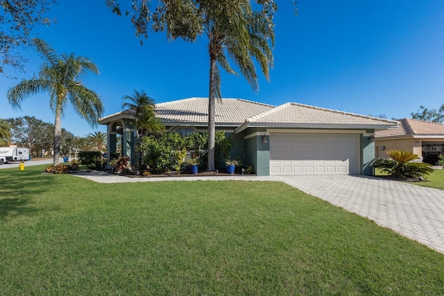 view of front of home featuring a garage and a front lawn