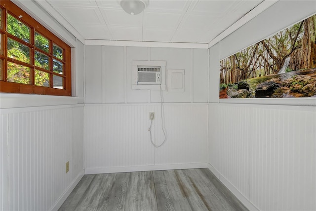 spare room featuring an AC wall unit and light hardwood / wood-style floors