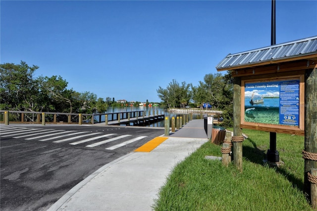 view of home's community featuring a boat dock and a water view