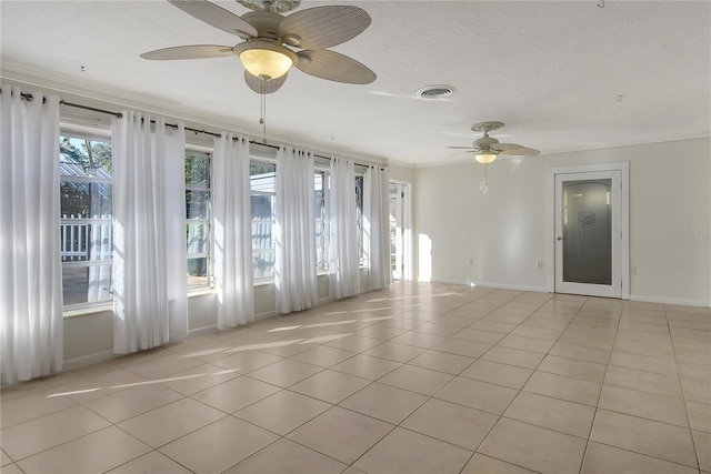 tiled empty room with ceiling fan and ornamental molding