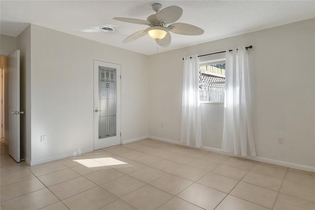 spare room featuring ceiling fan and light tile patterned flooring