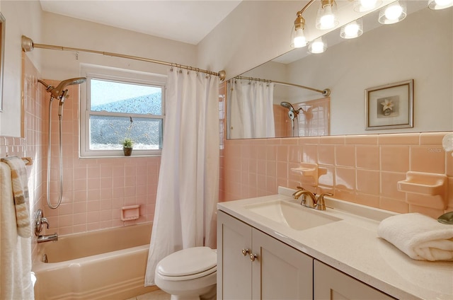 full bathroom featuring vanity, shower / bathtub combination with curtain, toilet, and tile walls