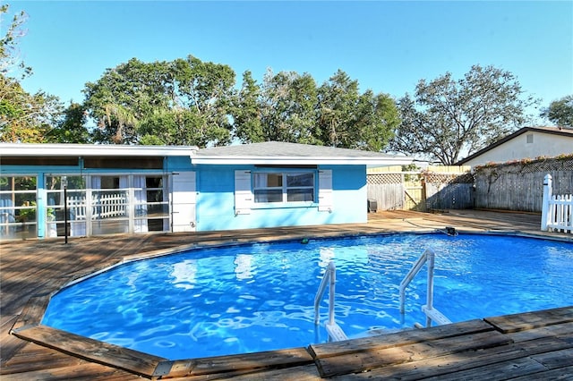 view of swimming pool featuring a deck