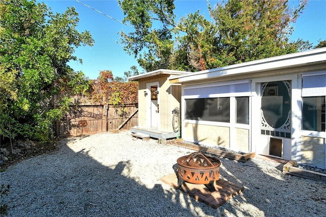 exterior space with an outdoor fire pit and an outdoor structure