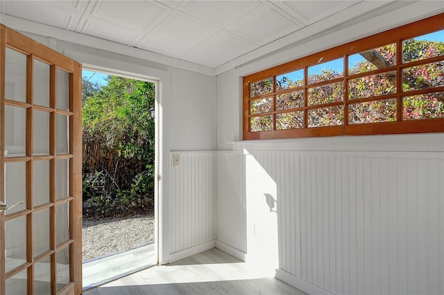 doorway to outside with an ornate ceiling and light wood-style floors