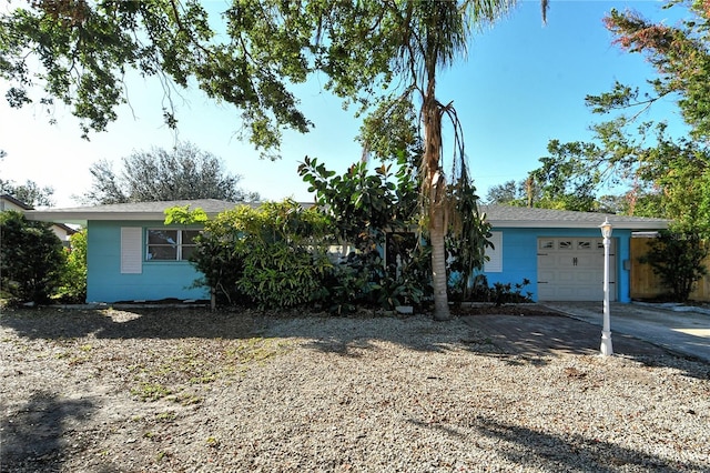 single story home with a garage and driveway