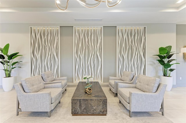 living area featuring light tile patterned floors and a chandelier