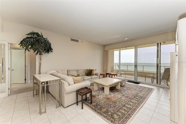 tiled living room with a water view