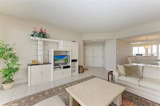 living room featuring ceiling fan and light tile patterned floors