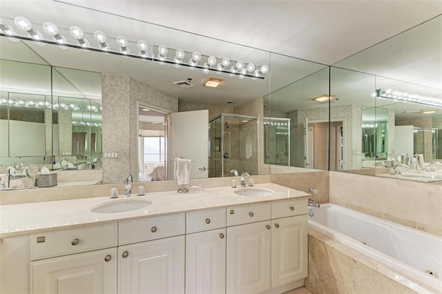 bathroom with vanity and independent shower and bath