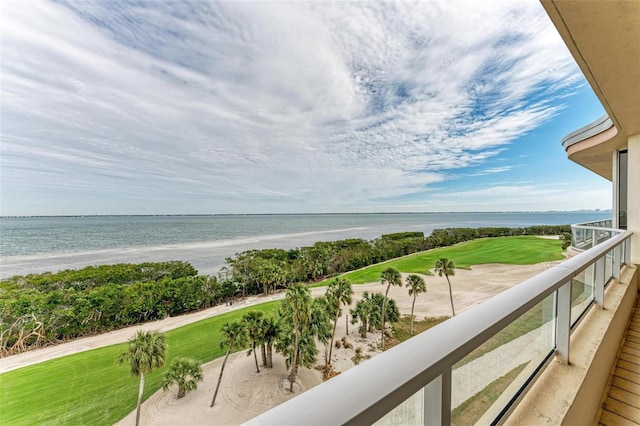 balcony with a water view and a beach view