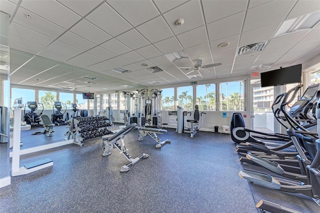 workout area featuring a drop ceiling and ceiling fan