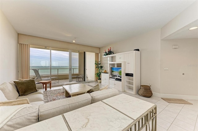 living area with light tile patterned floors and baseboards