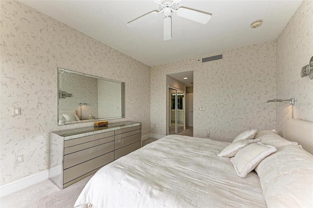 bedroom featuring a closet, visible vents, carpet flooring, ceiling fan, and wallpapered walls