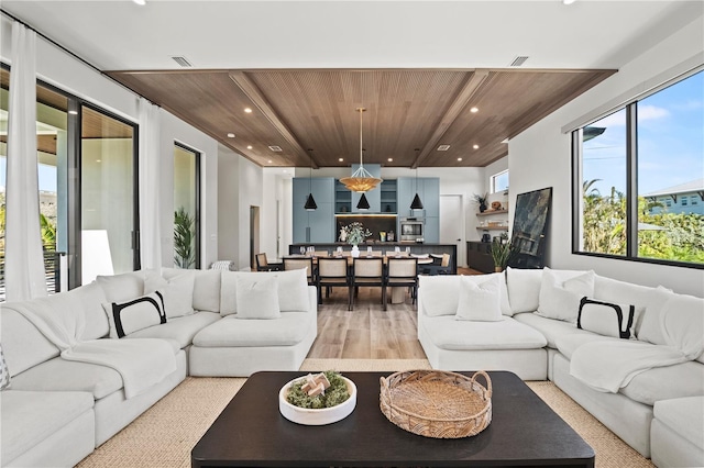 living room featuring light wood-type flooring and wood ceiling