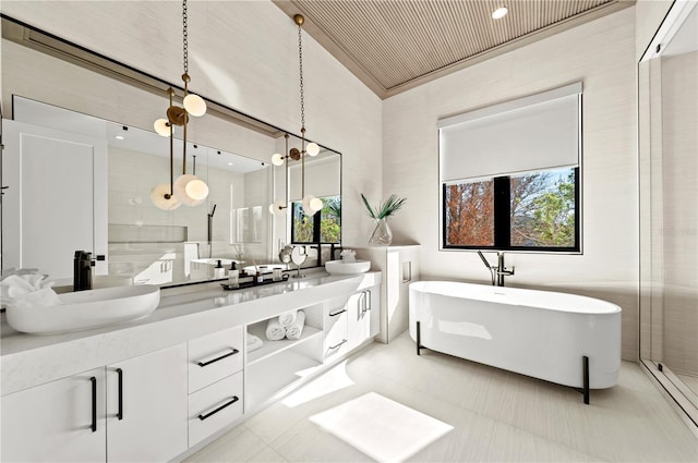 bathroom featuring plus walk in shower, vanity, tile patterned floors, and tile walls