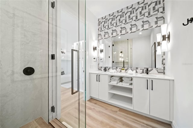 bathroom with vanity and a shower with door