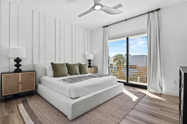 bedroom featuring access to outside, ceiling fan, and hardwood / wood-style flooring