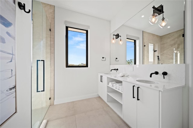 bathroom featuring tile patterned floors, vanity, and a shower with door