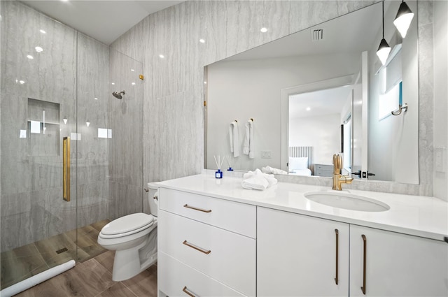 bathroom with vanity, toilet, and an enclosed shower