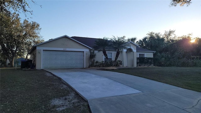 single story home with a yard and a garage