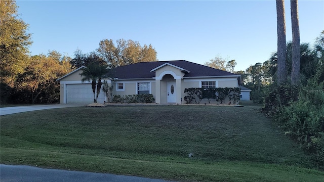 single story home with a front yard and a garage