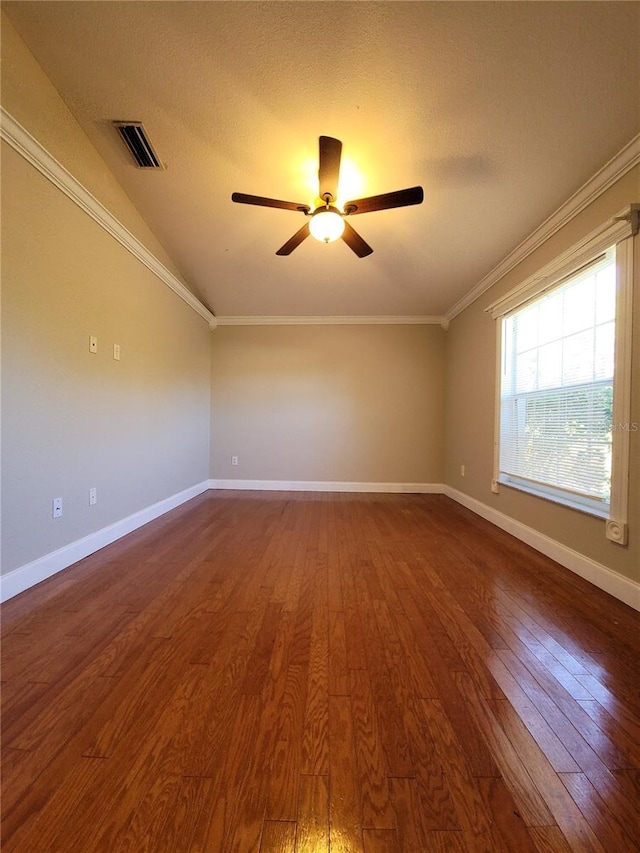 spare room with dark hardwood / wood-style floors, vaulted ceiling, ceiling fan, and ornamental molding