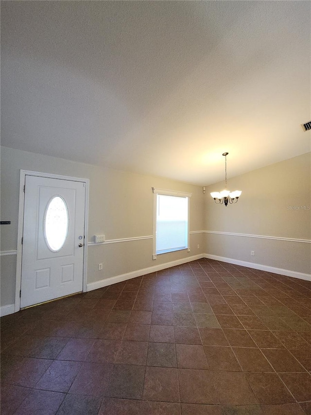 entryway with an inviting chandelier