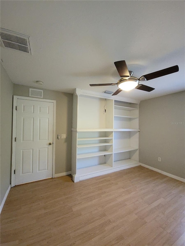 unfurnished bedroom with ceiling fan and light wood-type flooring