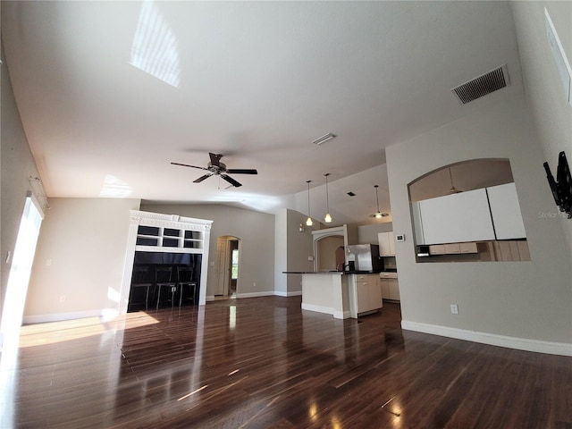 unfurnished living room featuring dark hardwood / wood-style floors, ceiling fan, and lofted ceiling