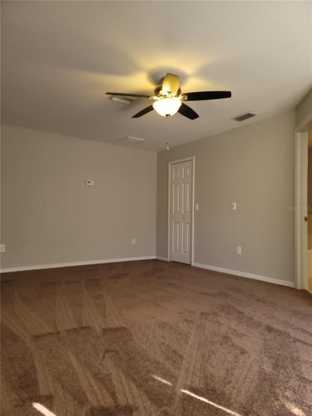 empty room with carpet flooring and ceiling fan