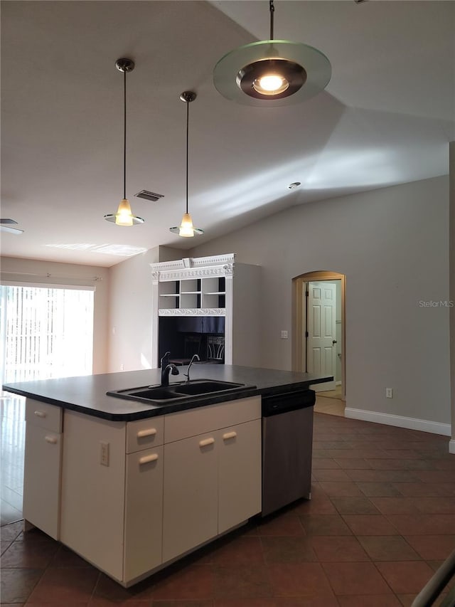 kitchen featuring dishwasher, lofted ceiling, sink, hanging light fixtures, and white cabinetry