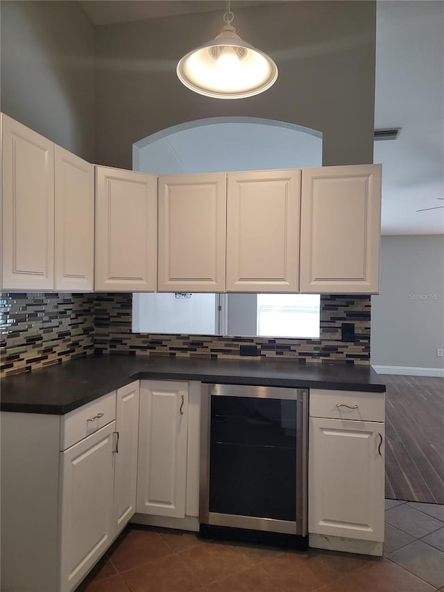 kitchen featuring white cabinets, pendant lighting, wine cooler, and dark tile patterned flooring