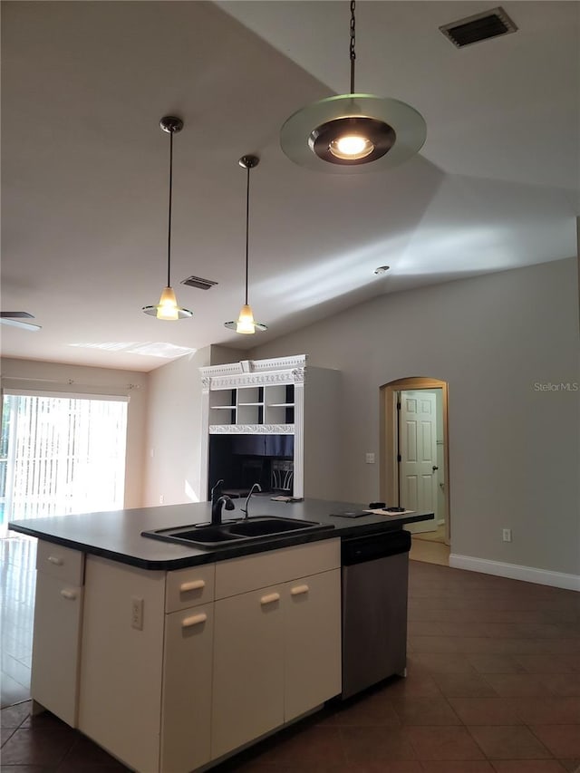 kitchen featuring stainless steel dishwasher, vaulted ceiling, sink, decorative light fixtures, and white cabinets