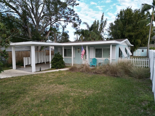 view of front of property with a front yard and a carport