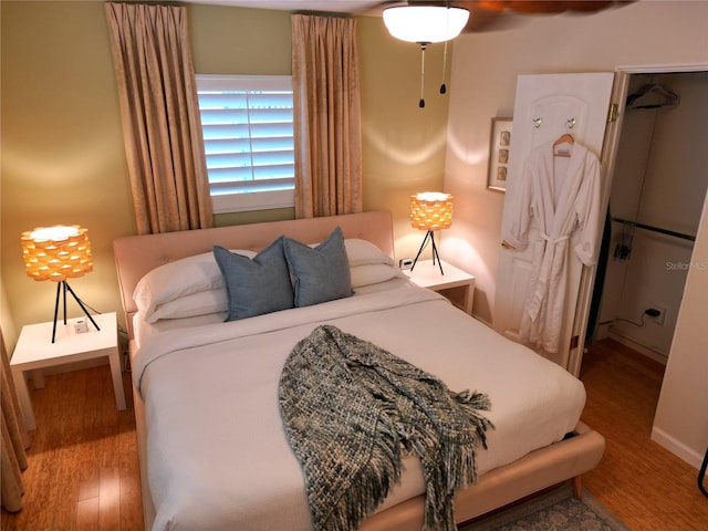 bedroom with hardwood / wood-style floors and ceiling fan