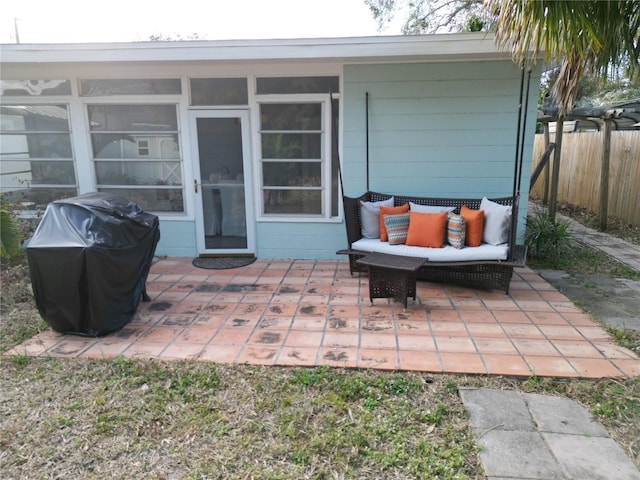 view of patio featuring area for grilling and a sunroom