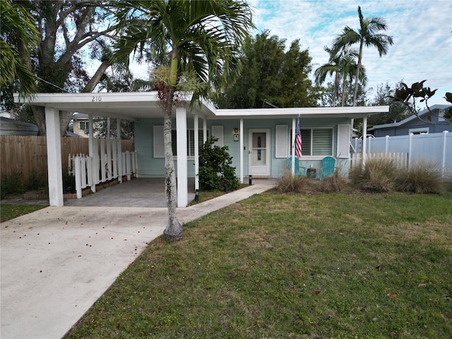 view of front of property with a front yard, a carport, and covered porch