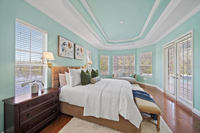 bedroom featuring access to exterior, french doors, a raised ceiling, dark hardwood / wood-style floors, and ornamental molding