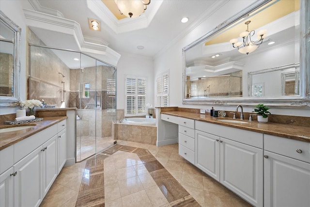 bathroom with a chandelier, vanity, separate shower and tub, and ornamental molding