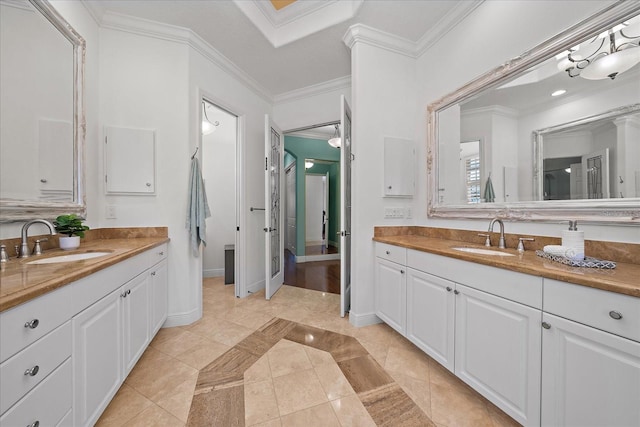 bathroom featuring tile patterned flooring, vanity, and crown molding