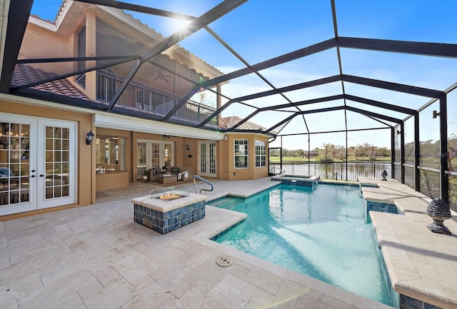 view of swimming pool with an in ground hot tub, french doors, ceiling fan, a water view, and a patio