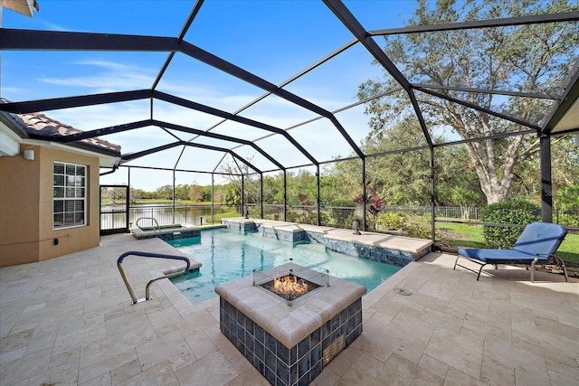 view of swimming pool featuring glass enclosure, a fire pit, pool water feature, a water view, and a patio