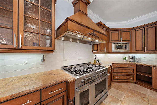 kitchen with backsplash, premium range hood, light stone counters, ornamental molding, and stainless steel appliances