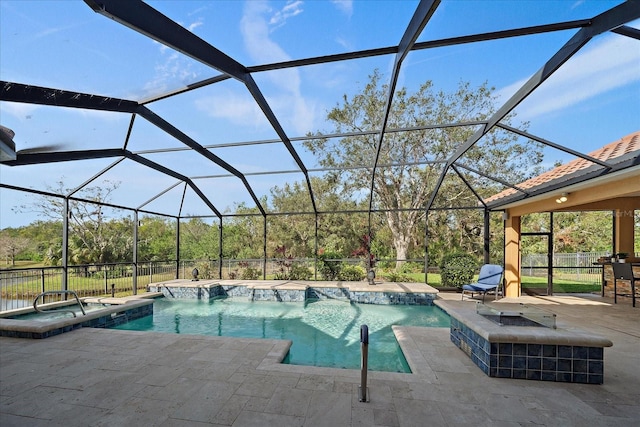 view of swimming pool featuring an in ground hot tub, a patio, pool water feature, and a lanai